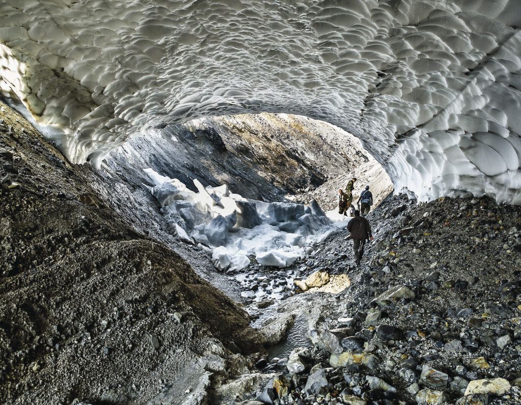Paramushir Island is one of the northernmost of the Kuril Islands. When warm streams melt large deposits of snow, beautiful tunnels are formed, large enough for a person to walk through.